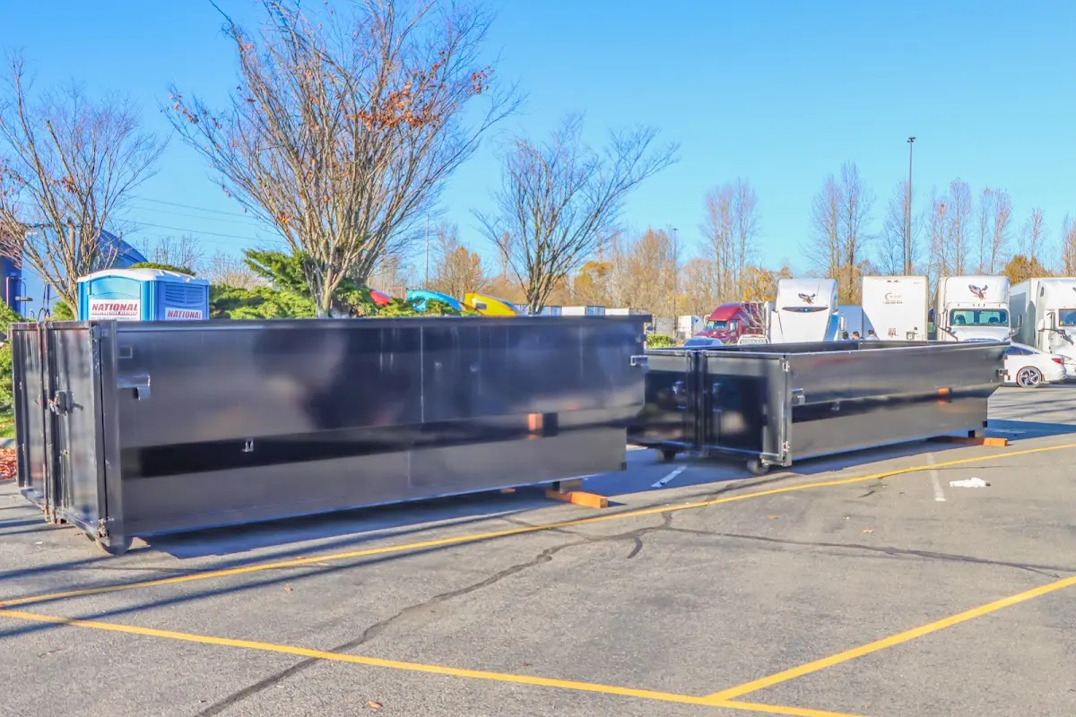 Professional dumpster rental service with roll-off container on residential driveway in Blakely